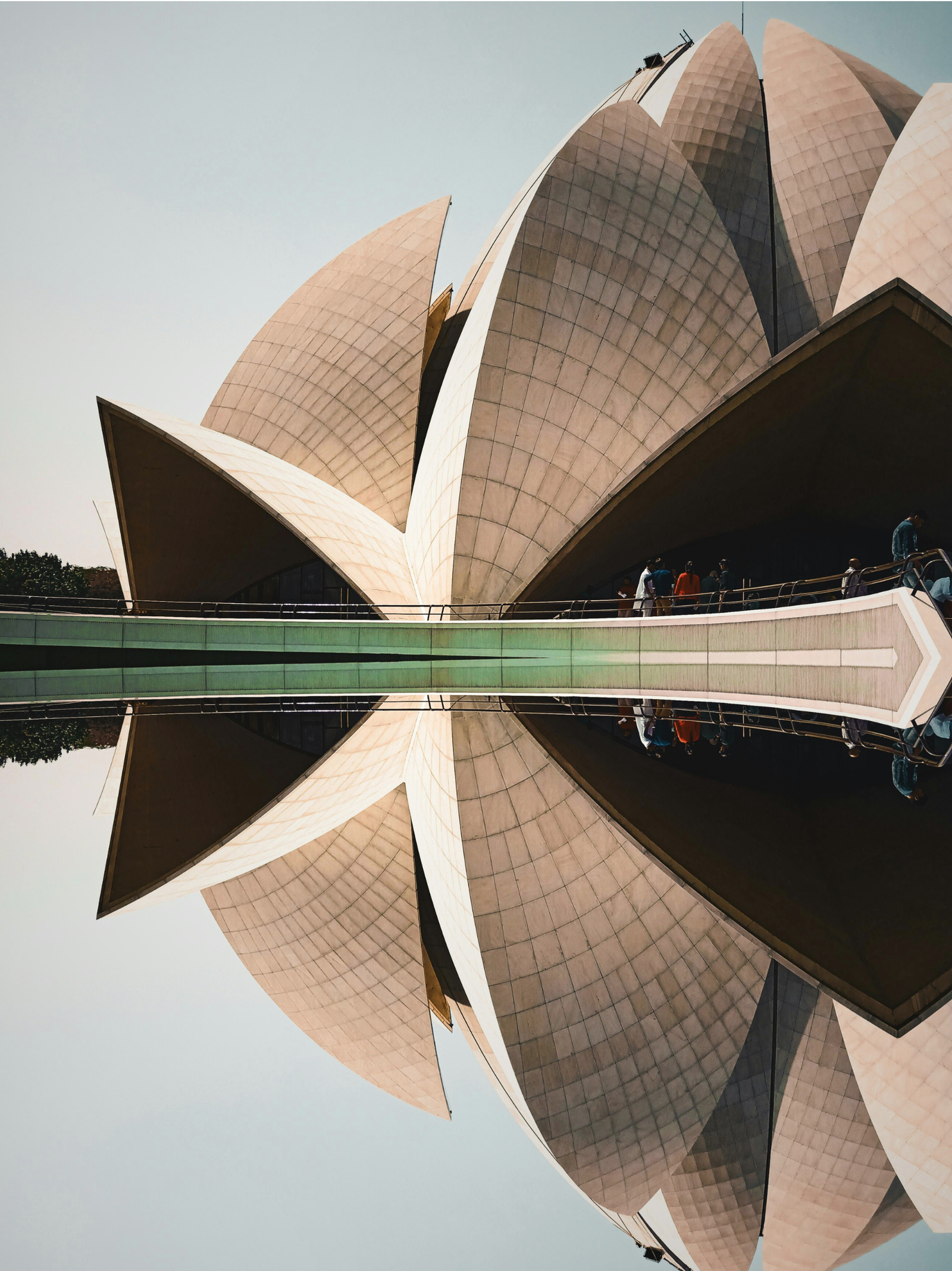 Side view of Lotus Temple in New Delhi, showcasing the concrete petals that lend the building the appearance of the flower it is named after